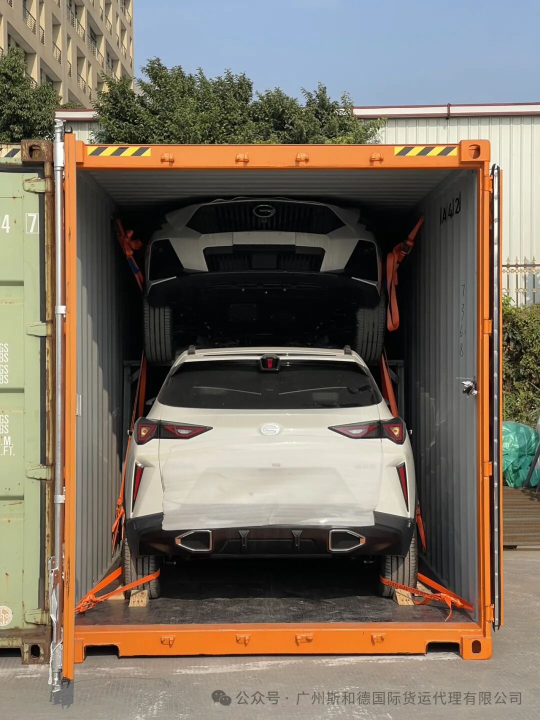 Professional team securing vehicles with heavy-duty lashing inside an enclosed Ro-Ro deck